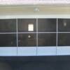 Aluminum framed sliding screen doors for garage openings